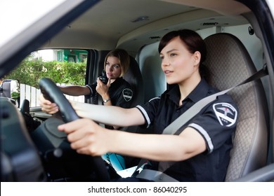 Female EMT Calling Dispatcher On Radio - Shallow Depth Of Field, Focus On Woman With Radio