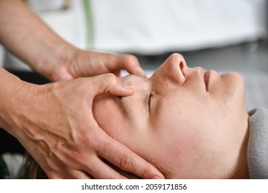 Female energy massage shiatsu relaxing and care treatment for body and mindfull health gentle woman arms holding head doing access bars and face young procedure - Powered by Shutterstock