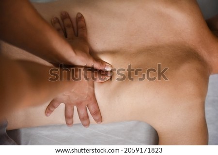 Female energy massage shiatsu relaxing and care treatment for body and mindfull health gentle woman arms doing back close up