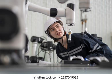 Female engineer control autonomous mobile robot or AMR in the laboratory room. Woman engineer training or maintenance AI robot