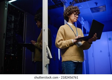 Female Engineer Examining Data On Laptop