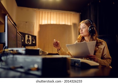 Female engineer in headphones, recording studio - Powered by Shutterstock