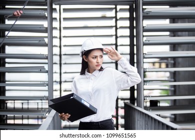 Female engineer inspecting construction work in hand holding cli