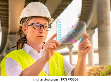 Female Engineer Or Inspector At Bridge Construction Site Working On Futuristic Gadget Analyzing Data.