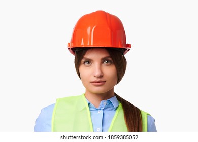 Female engineer in protective helmet and a green vest on white isolated background