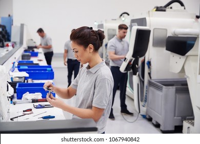 Female Engineer Quality Controlling Components In Factory - Powered by Shutterstock