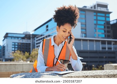 Female Engineer Talking on Phone and Taking Notes At Construction Site - Powered by Shutterstock