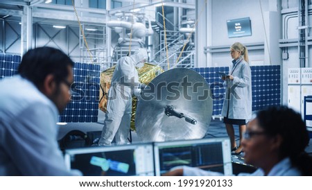 Female Engineer uses Computer to Analyse Satellite, Calculate Orbital Trajectory Tracking. Aerospace Agency International Space Mission: Scientists Working on Spacecraft Construction.