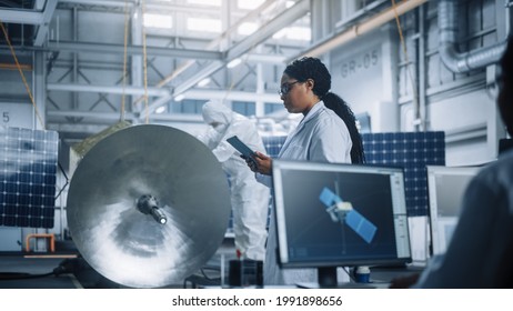 Female Engineer Uses Tablet Computer while Working on Satellite Construction. Aerospace Agency Manufacturing Facility: Scientists Build, Assemble Spacecraft for Space Exploration, Observation Mission - Powered by Shutterstock