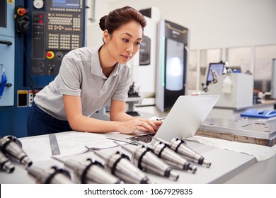 Female Engineer Using CAD Programming Software On Laptop