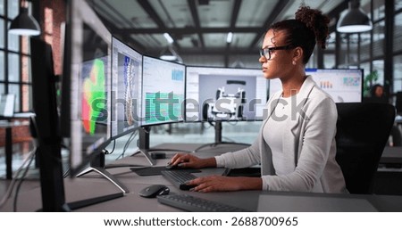 Female Engineer Using CAD Software To Design Mechanical Parts For Car