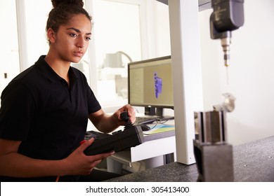 Female Engineer Using CAD System To Work On Component