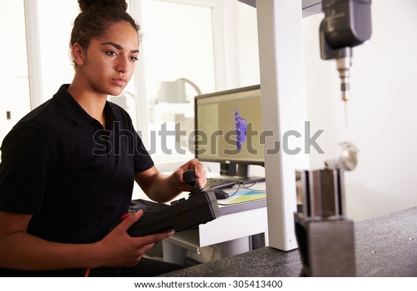 Female\
Engineer Using CAD System To Work On\
Component