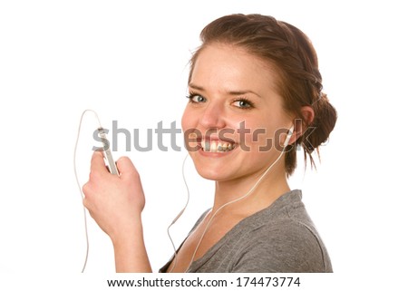 Female Enjoying Music - This is a photo of a cute young woman ready to listen to some music on her iPod. Shot on an isolated white background with a shallow depth of field.