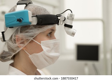 A Female ENT Doctor In A White Coat And A Mask Is In The Modern Office Of An ENT Hospital, Close-up