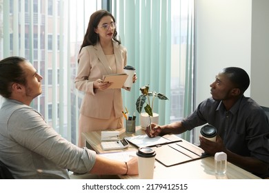 Female Entrepreneur Giving Tasks To Team Member During Daily Briefing