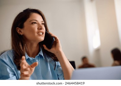 Female entrepreneur making a phone call while working in the office. Copy space. - Powered by Shutterstock