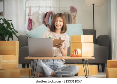 Female Entrepreneur Online Store Owner Using Laptop At Work Preparing Parcel Boxes Checking Ecommerce Post Shipping Online Retail E Commerce Store Order Fulfillment In Dropshipping Delivery Warehouse.