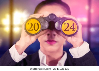 Female entrepreneur using binoculars with the 2024 new year numbers on it