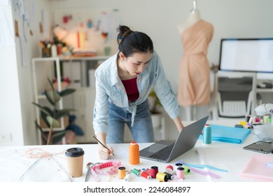 Female entrepreneurs are making new clothing collections from her design with a modern. - Powered by Shutterstock