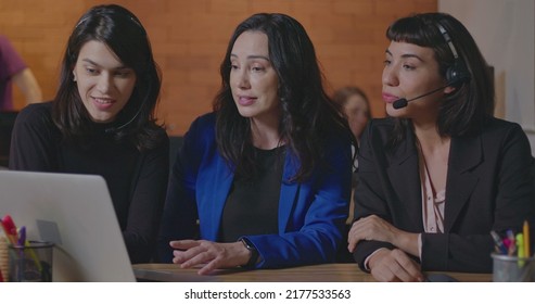 Female Executive Presenting Data To Staff In Front Of Computer Laptop. Female Employees Listening To Female Leader Explaining Information