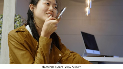 Female executive talking on mobile phone in office cafeteria - Powered by Shutterstock