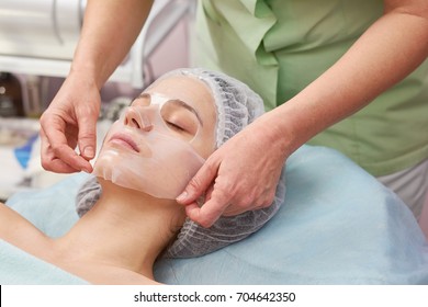 Female Face, Hands Of Cosmetician. Woman With Hydrogel Mask.