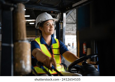 female factory worker. female forklift operator working in a warehouse. Portrait of young Indian woman driver sitting in forklift and smiling working in warehouse. - Powered by Shutterstock