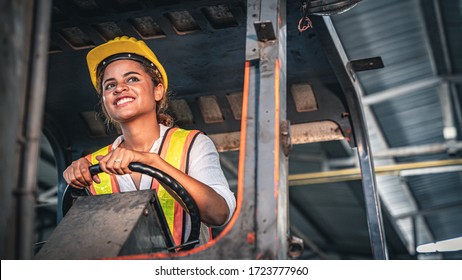 Female Factory Worker Operating Forklift In Warehouse.