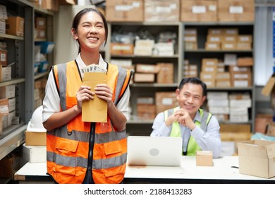 Female Factory Worker Or Warehouser Getting Money From Boss In The Warehouse Storage