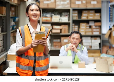Female Factory Worker Or Warehouser Getting Money From Boss In The Warehouse Storage