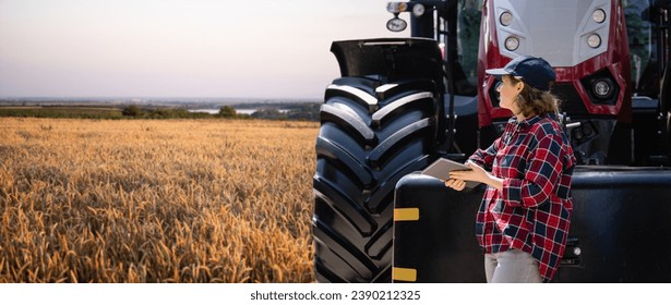 Female farmer with a digital tablet next to agricultural tractor. - Powered by Shutterstock