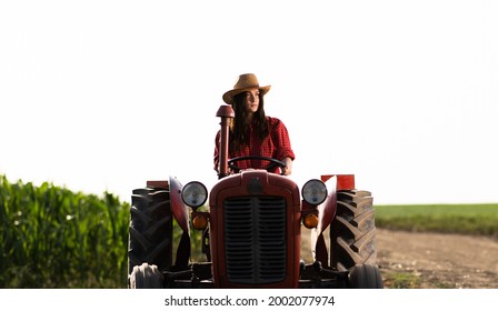 Female Farmer Driving A Tractor In Field