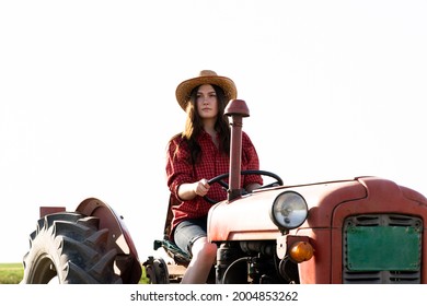 Female Farmer Driving A Tractor In Field