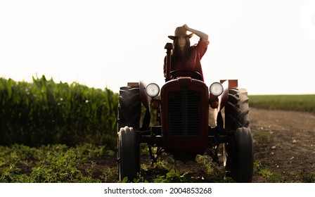 Female Farmer Driving A Tractor In Field