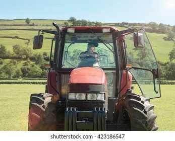 Female Farmer Driving Tractor In Field