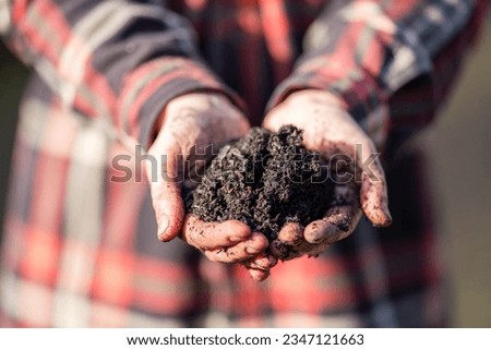 Female farmer hold soil in hands monitoring soil health on a farm in australia