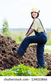 Female Farmer Works With Manure At Field