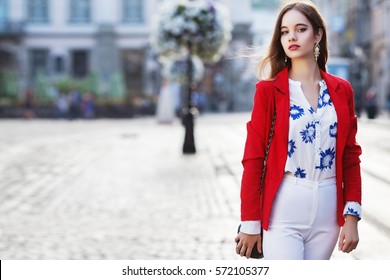 Female Fashion Concept. Outdoor Waist Up Portrait Of Young Beautiful Woman Posing On Old Street. Model Wearing Stylish Clothes, Looking At Camera. Sunny Day. City Lifestyle. Copy, Empty Space For Text