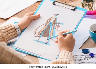 Female fashion designer working with sketches in studio, closeup - Shutterstock ID 2036852918