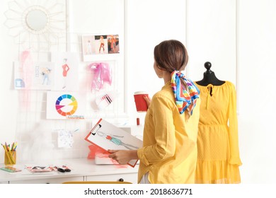 Female fashion designer working in studio - Powered by Shutterstock