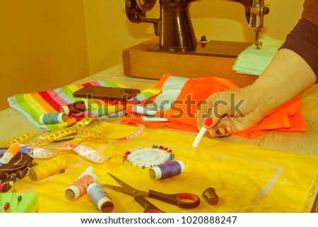 Female fashion designer working at studio with pattern cuttings and sketches. Garment industry, tailoring concept