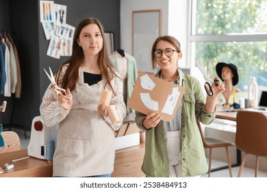 Female fashion designers with supplies in studio - Powered by Shutterstock