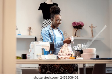 Female fashion tailor working on the measurements for the dress design in her workshop. - Powered by Shutterstock