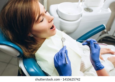 Female Feeling Painful Toothache. Teeth Problem Woman Feeling Tooth Pain. Social Medicine, Budget Dental Clinic In Poor Countries. Dentists Are Working.Dentist Examining A Patient's Teeth 