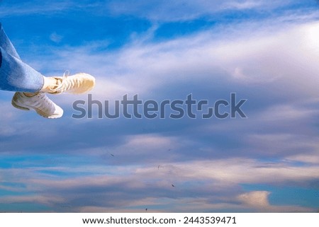 female feet against the blue sky