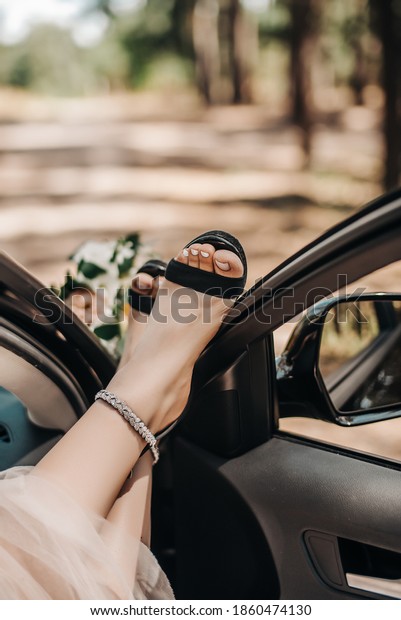 Female feet in the car\
window