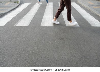 Female Feet Crossing The Crosswalk