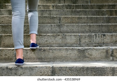 Female Feet In Gym Shoes To Climb The Stairs In The Daytime