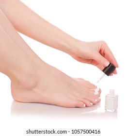 Female feet legs nail polish white in hands beauty on a white background isolation - Shutterstock ID 1057500416